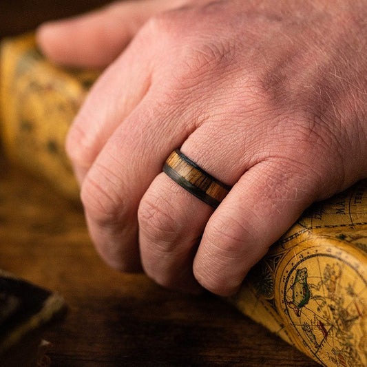 Man wearing a Carbon Fiber with U.S.S. New Jersey teak wood deck Wedding Ring - Manly Bands