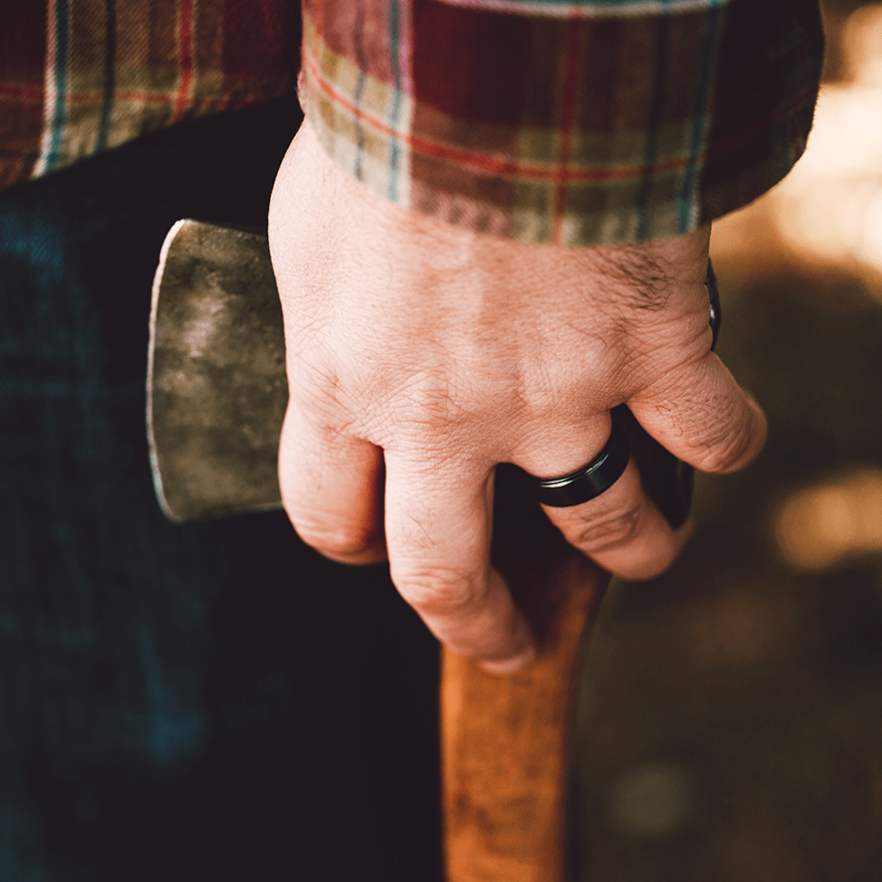 Man wearing a Black Zirconium (charcoal gray color) with Jack Daniel's Whiskey Barrel Wedding Ring- Manly Bands