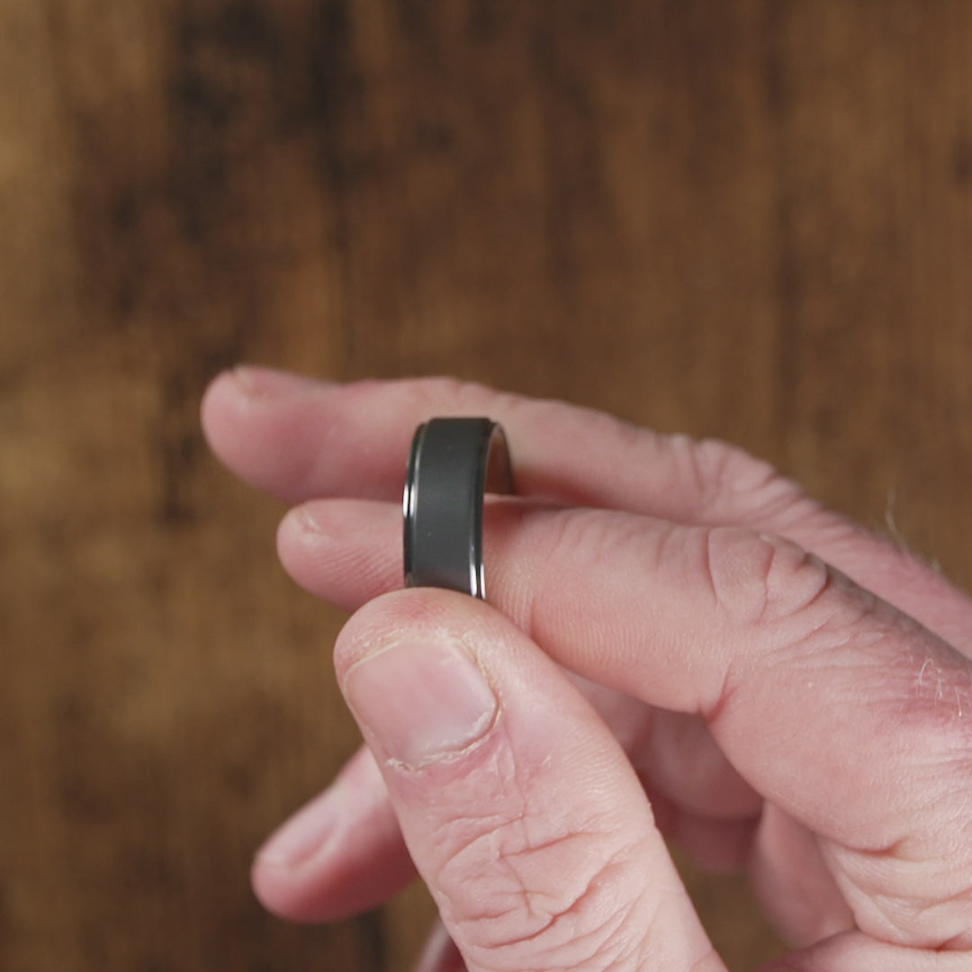 Trying on a men's wedding ring made of Black Zirconium (charcoal gray color) with Jack Daniel's Whiskey Barrel - Manly Bands